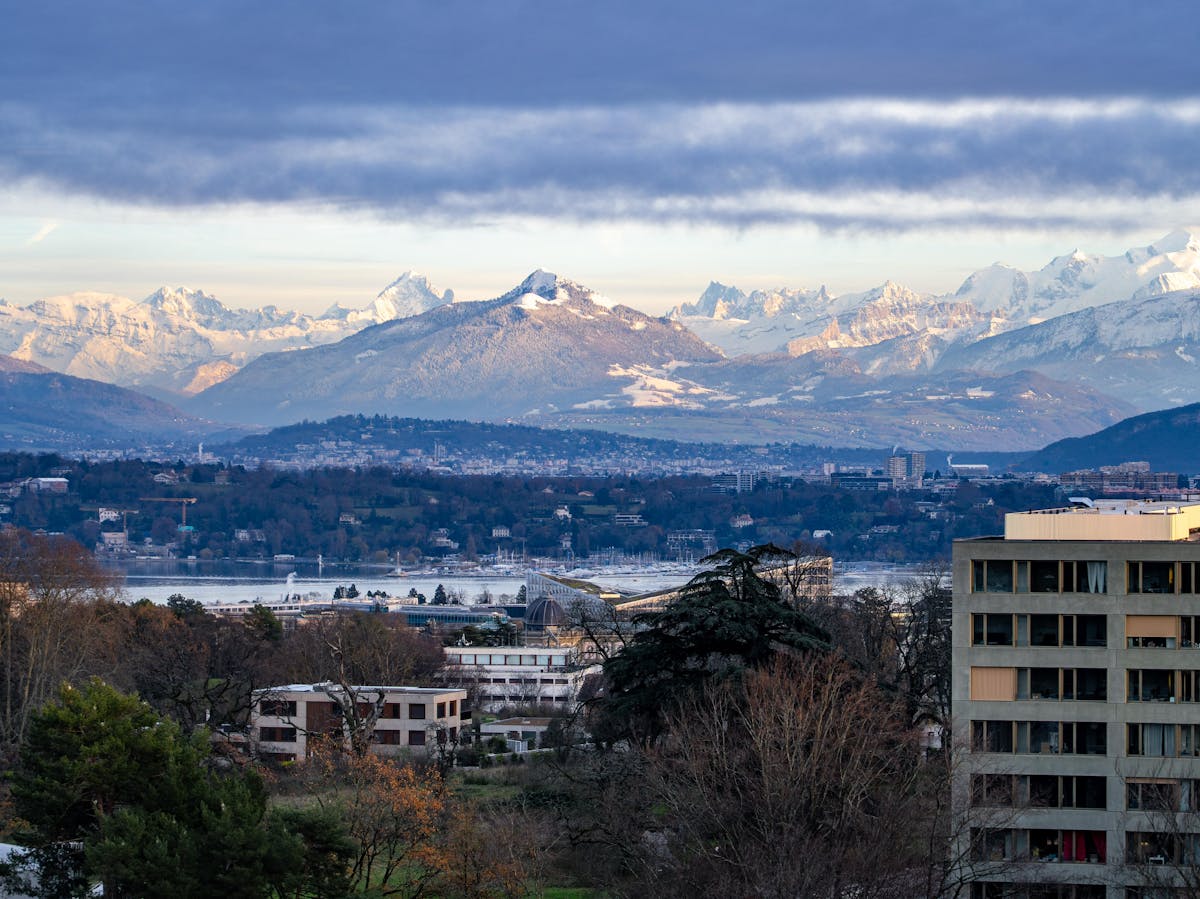 Panoramic view of Geneva Switzerland with Swiss Alps backdrop and Lake Geneva