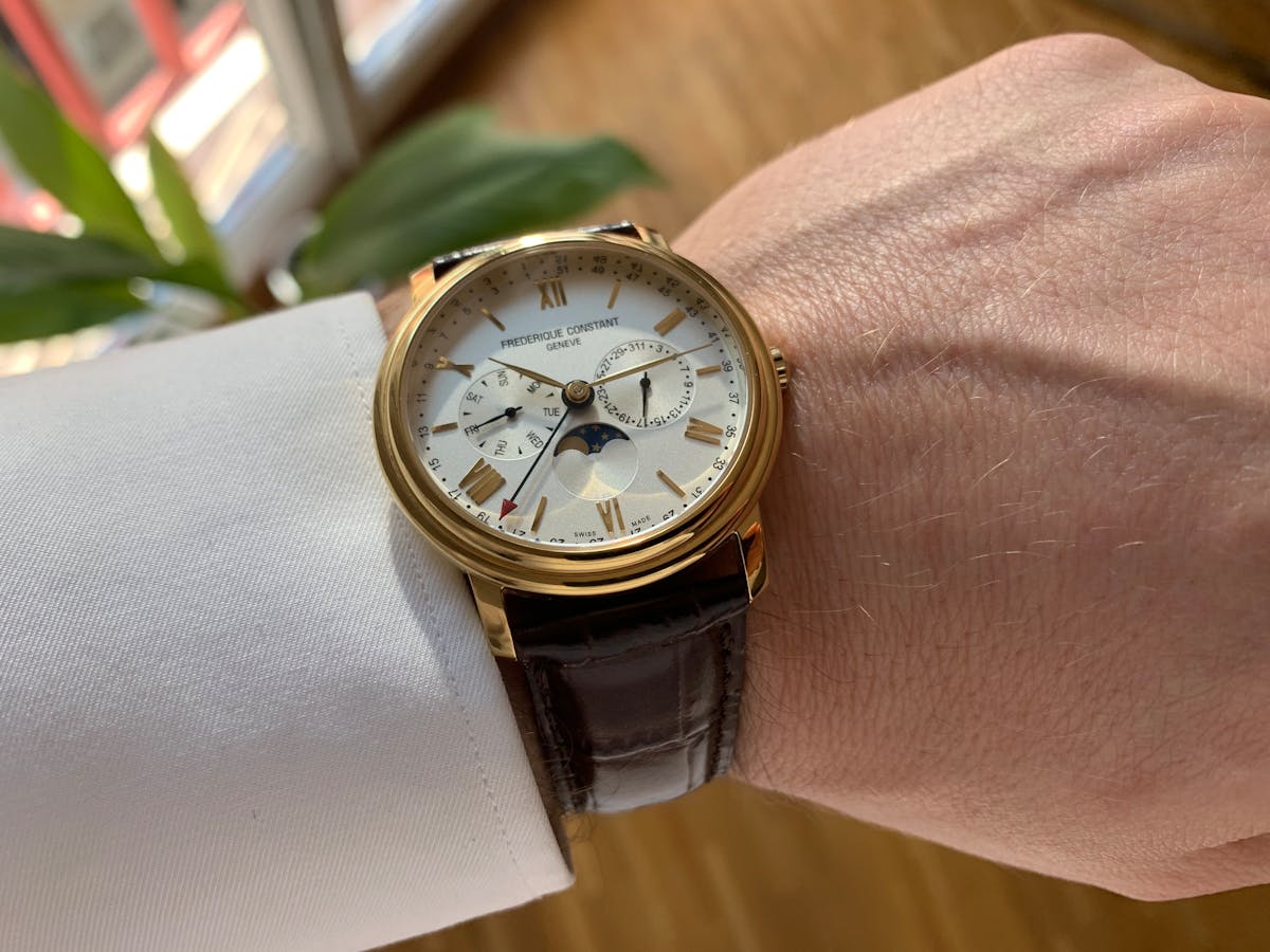 Luxury Swiss watch on wrist with Geneva cityscape backdrop watchmaking capital