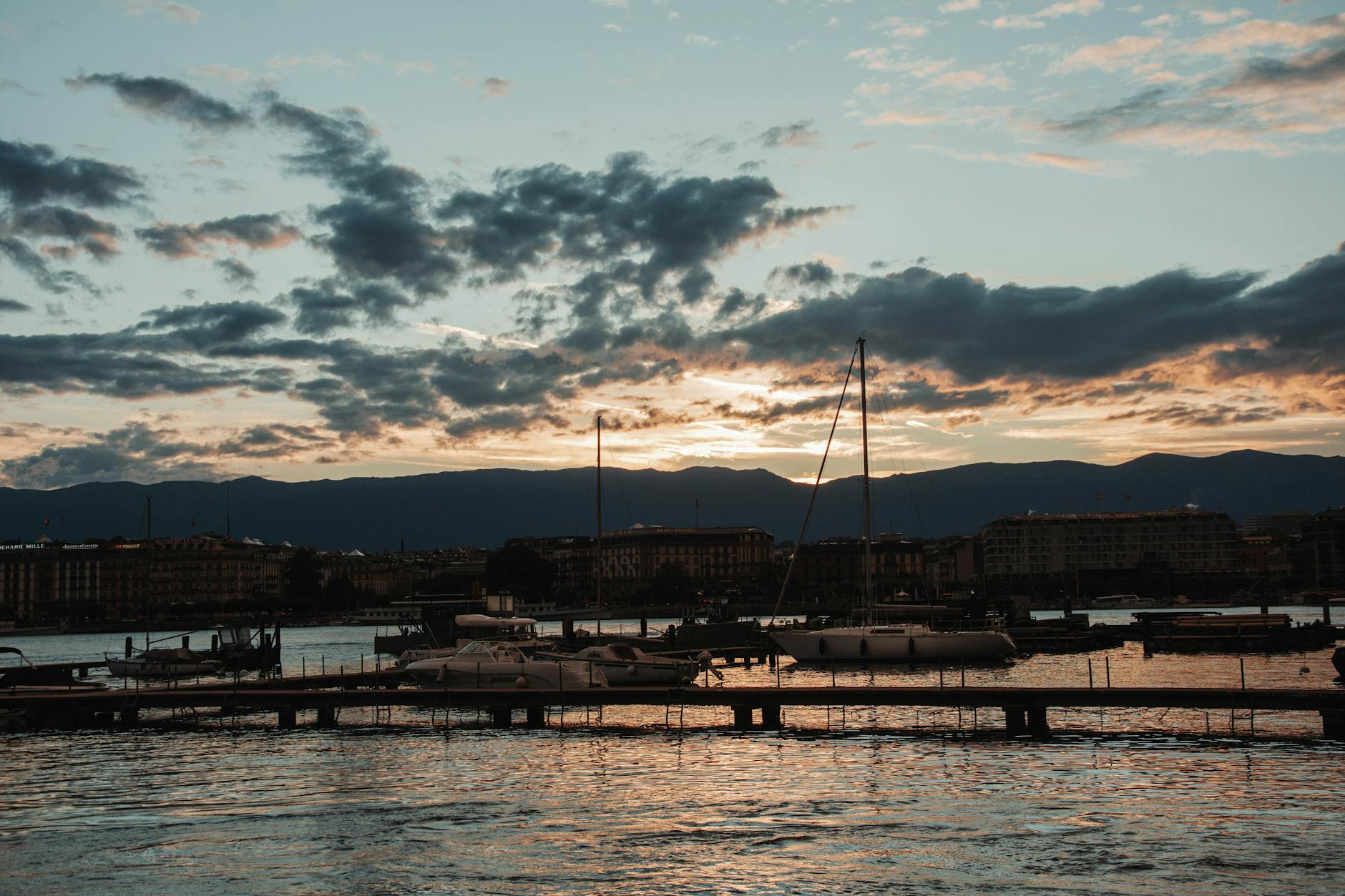 Beautiful sunset over Geneva waterfront with moored boats