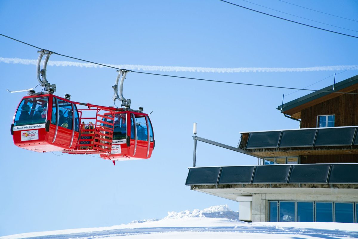 A gondola climbing an Alpine ski area within 90 minutes of Geneva airport