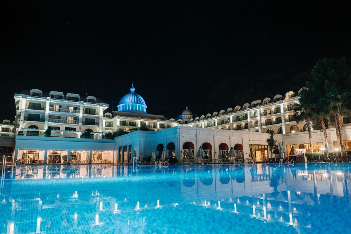 Indoor swimming pool lit blue at night, evoking the Antigel Club Piscine swim-and-dance event in Geneva