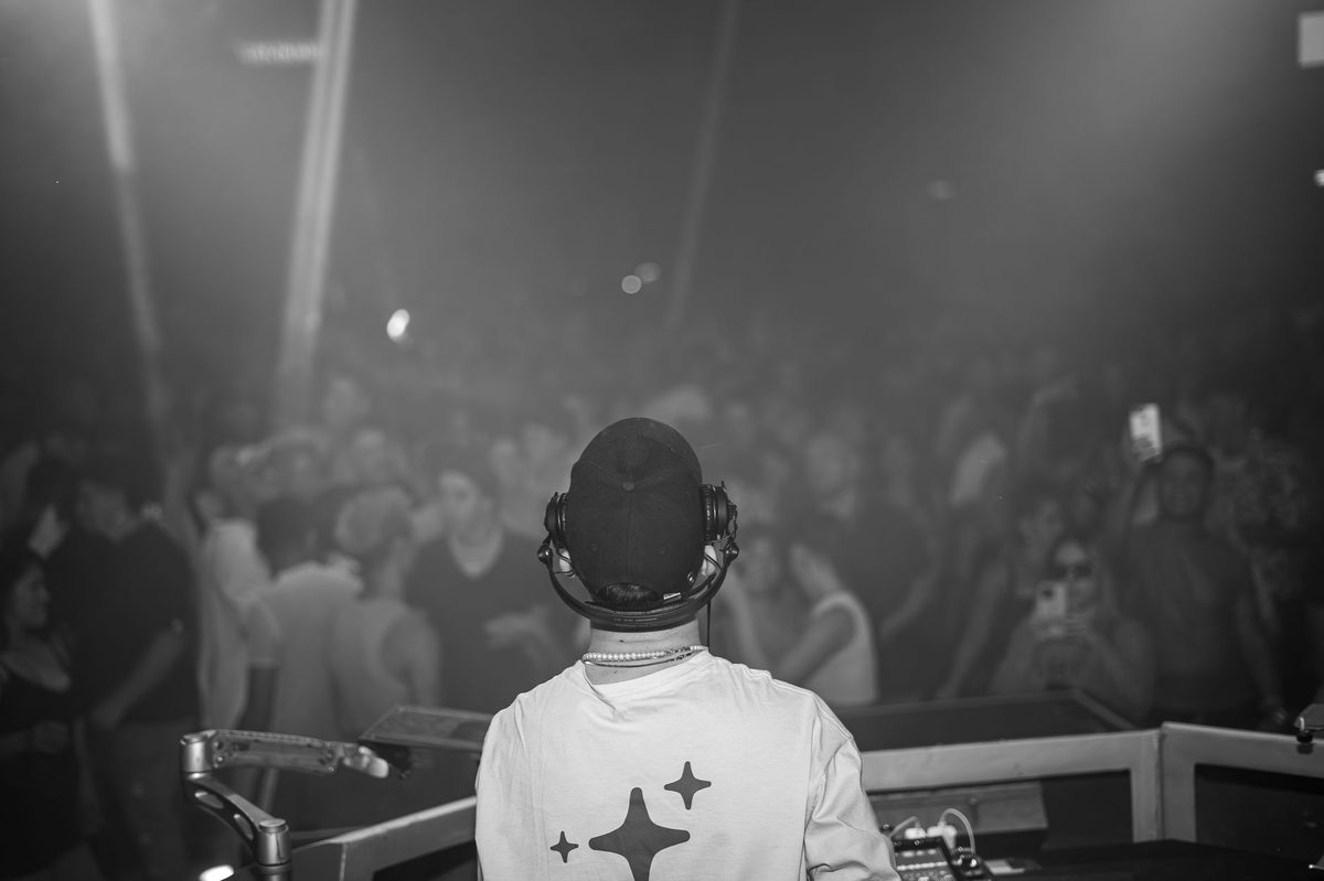 DJ playing to a club crowd, like the Antigel Grand Central electronic nights in a Geneva industrial hall
