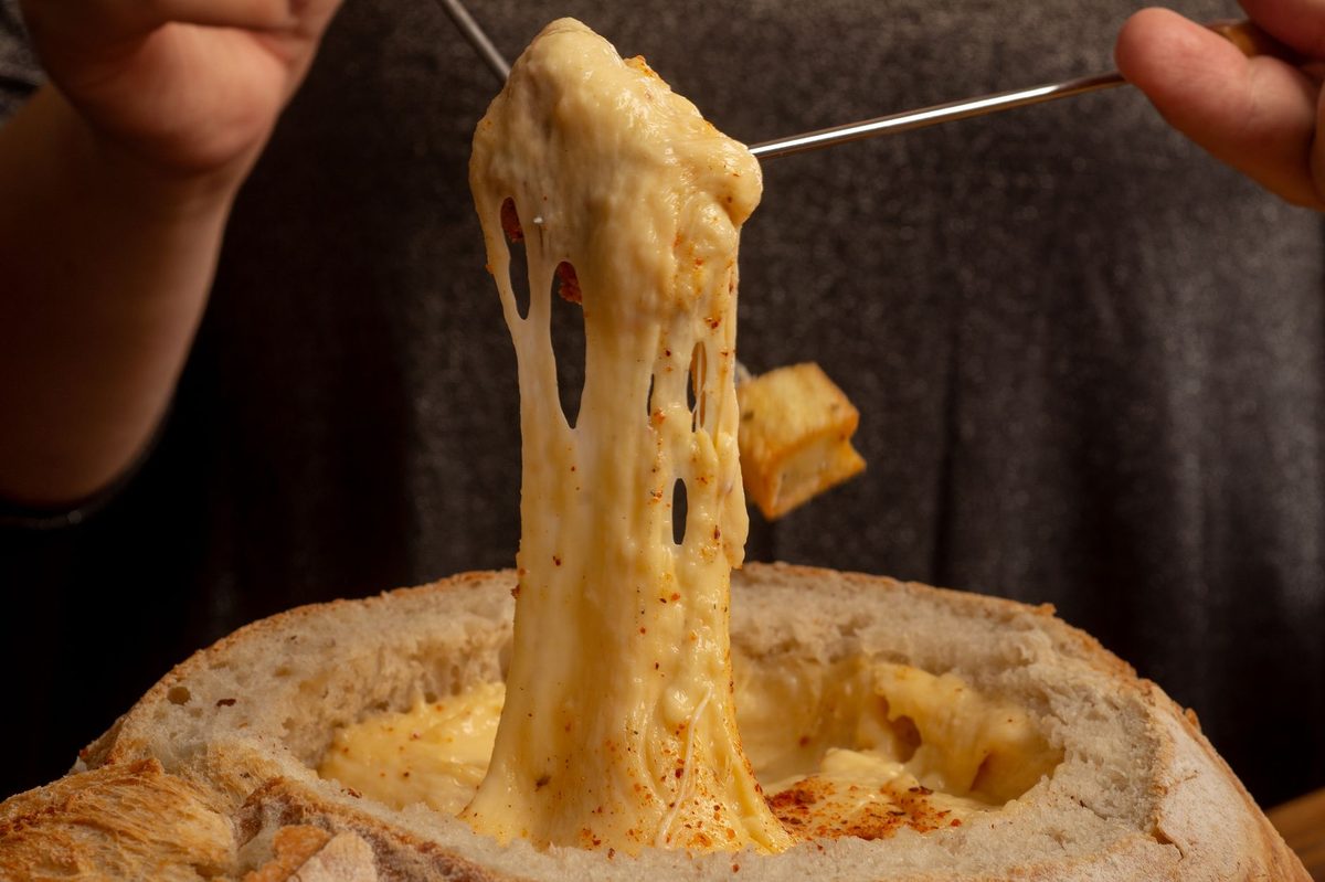 Swiss cheese fondue ready to share, the Bains des Paquis winter ritual