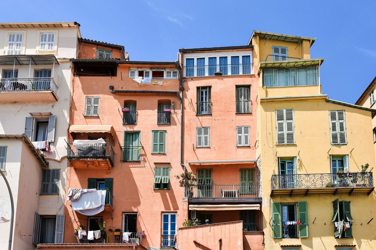 Pastel two-storey buildings with shutters on a grid street, the Mediterranean look of Carouge in Geneva