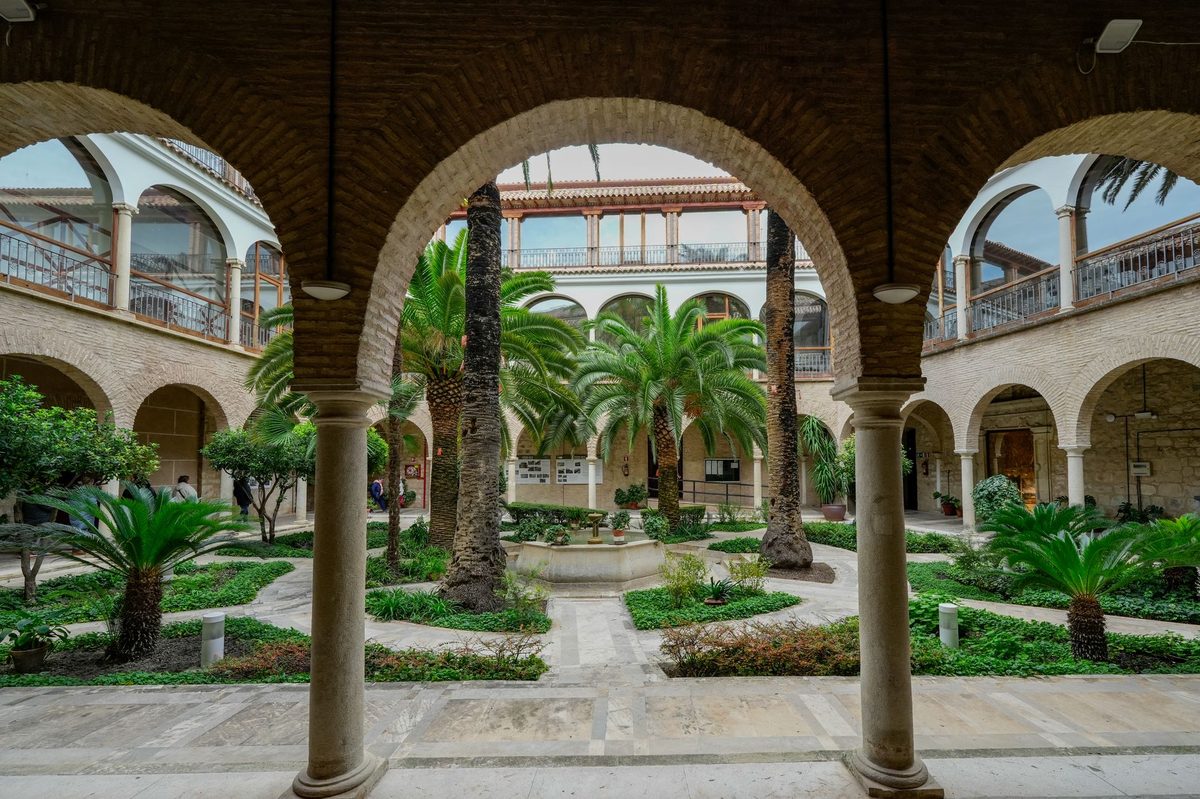 A planted interior courtyard behind a building, the hidden-courtyard feature of Carouge in Geneva