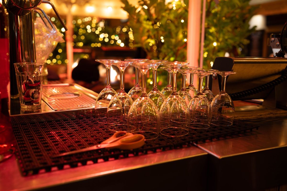 A wine bar lit up in the evening, reflecting Carouge's later-running nightlife in Geneva