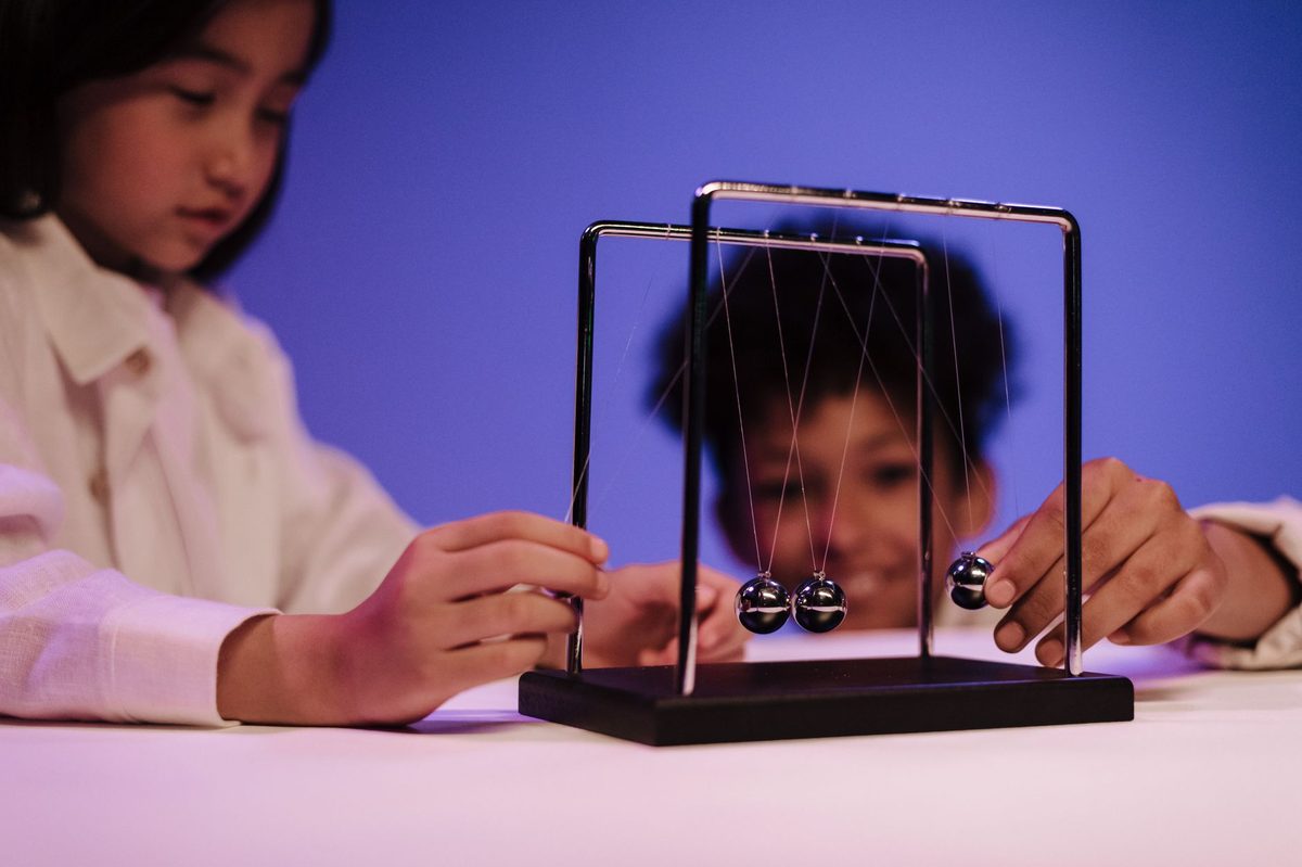 Kids at a hands-on science display like the CERN Science Gateway near Geneva