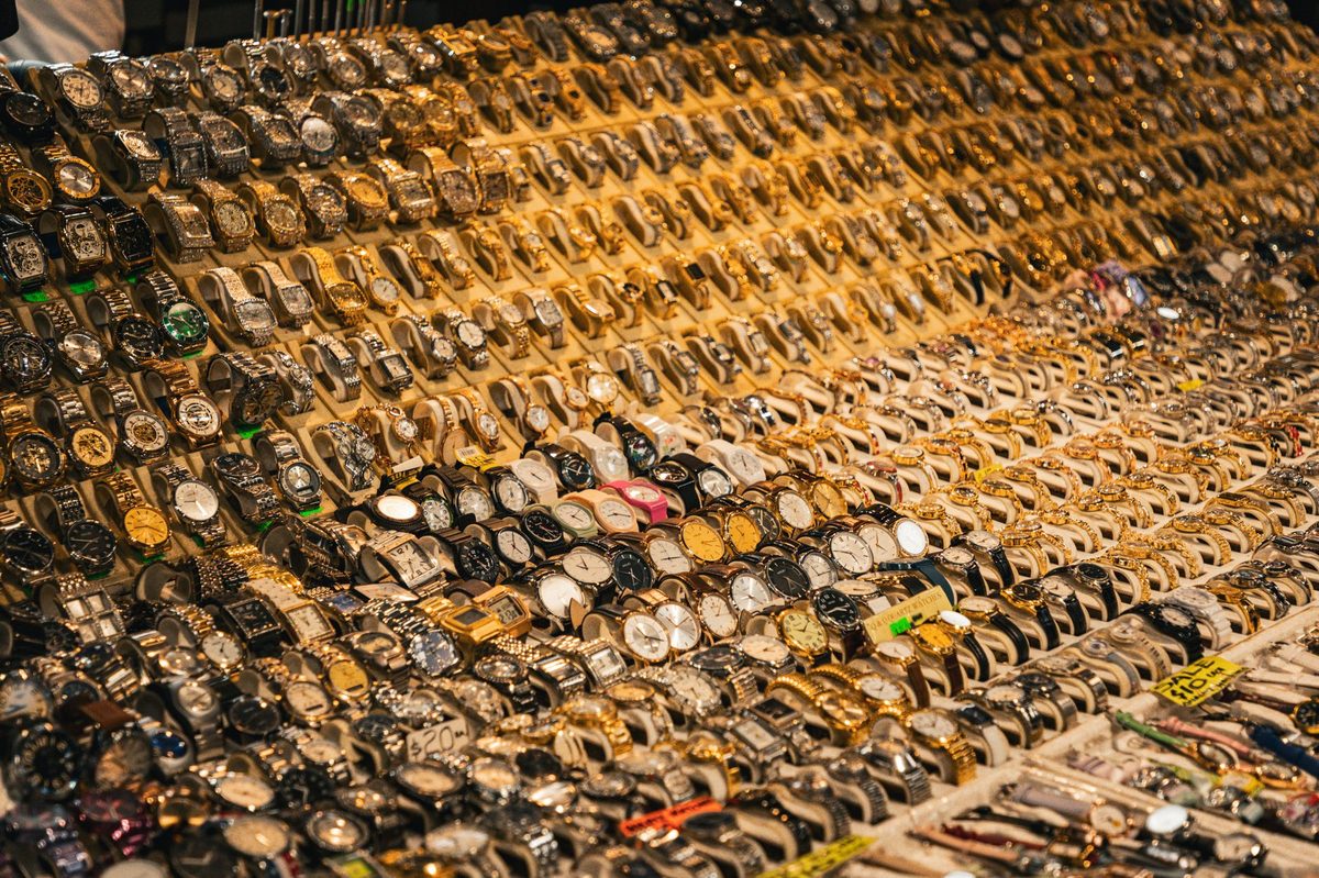 Vintage jewellery and watches on display, often counterfeit at flea markets