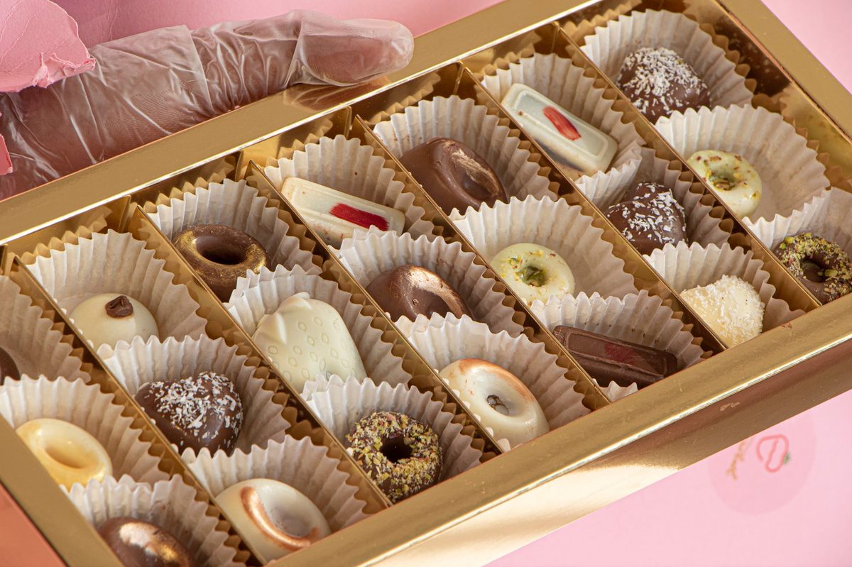 Artisan chocolate bonbons being finished by hand in Geneva