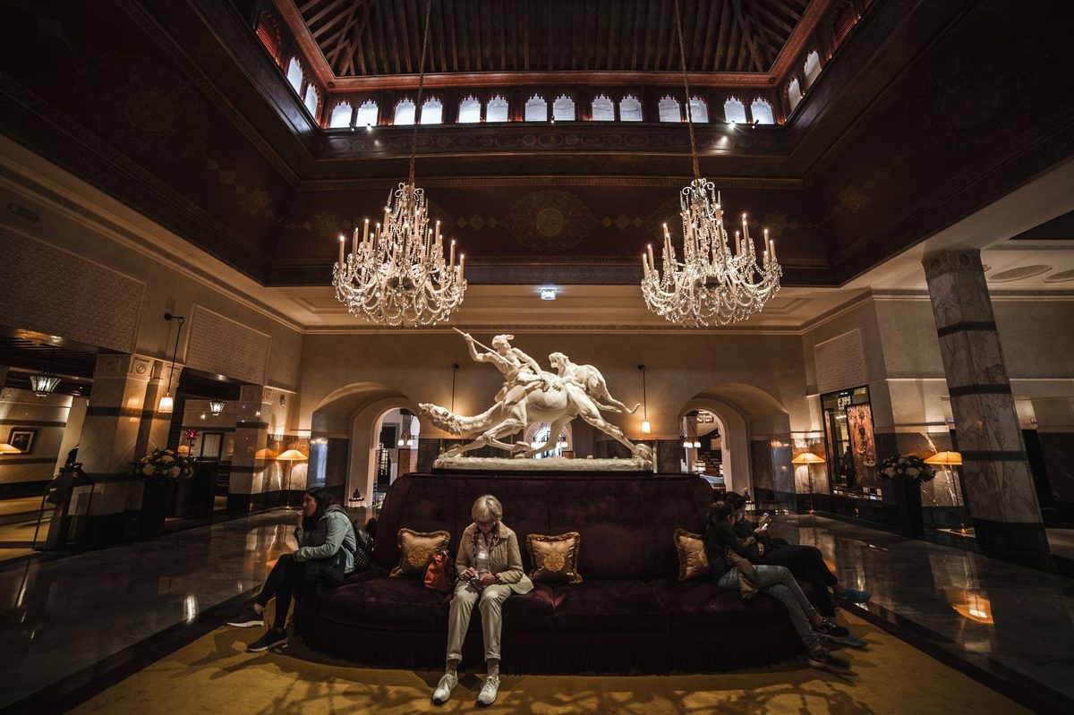 Belle Epoque hotel lobby with a chandelier, echoing the theatrical interiors of Hotel Tiffany