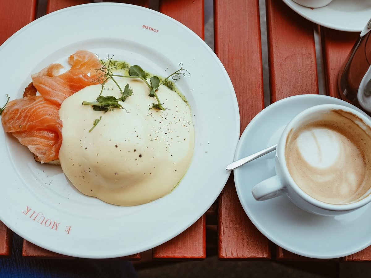 Brunch spread of eggs benedict, avocado toast and coffee in Geneva