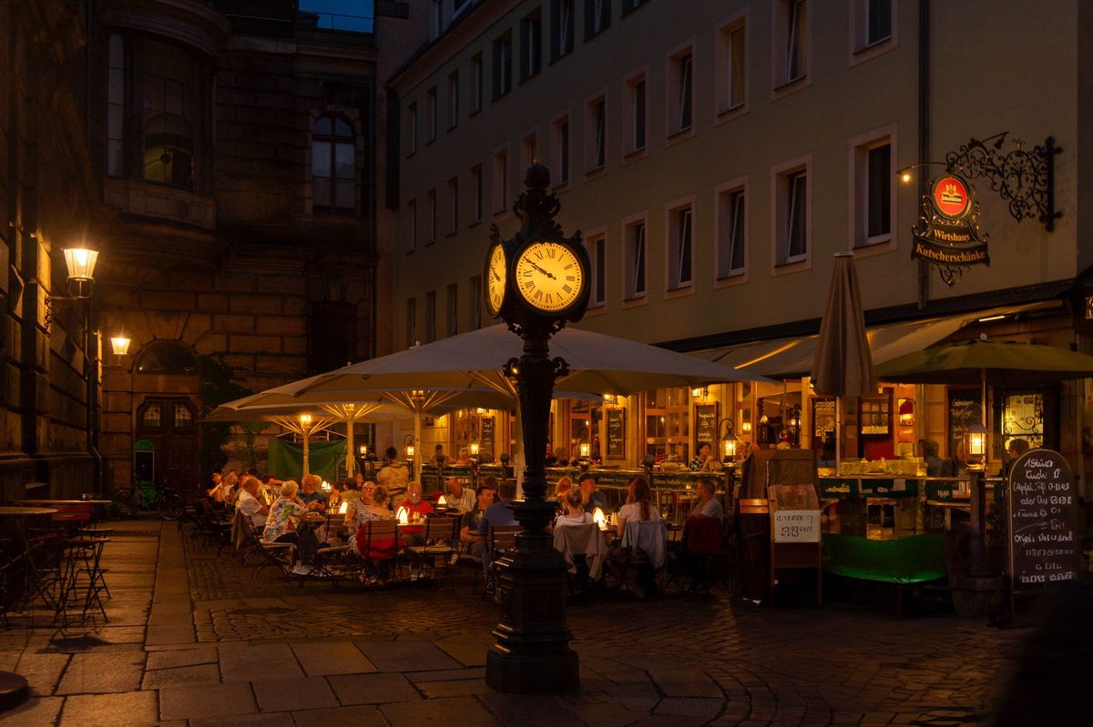 An outdoor cafe table in Geneva Old Town where a plat du jour lunch saves money