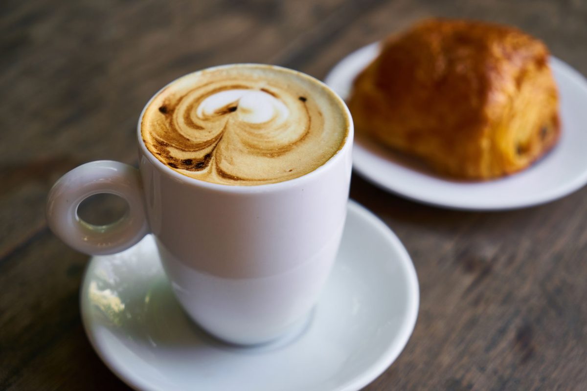 Cappuccino and croissant on a Geneva cafe table