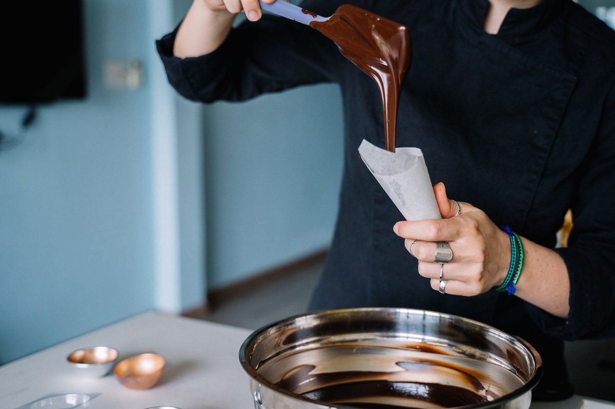 Chocolatier hand-making chocolates in a Geneva workshop