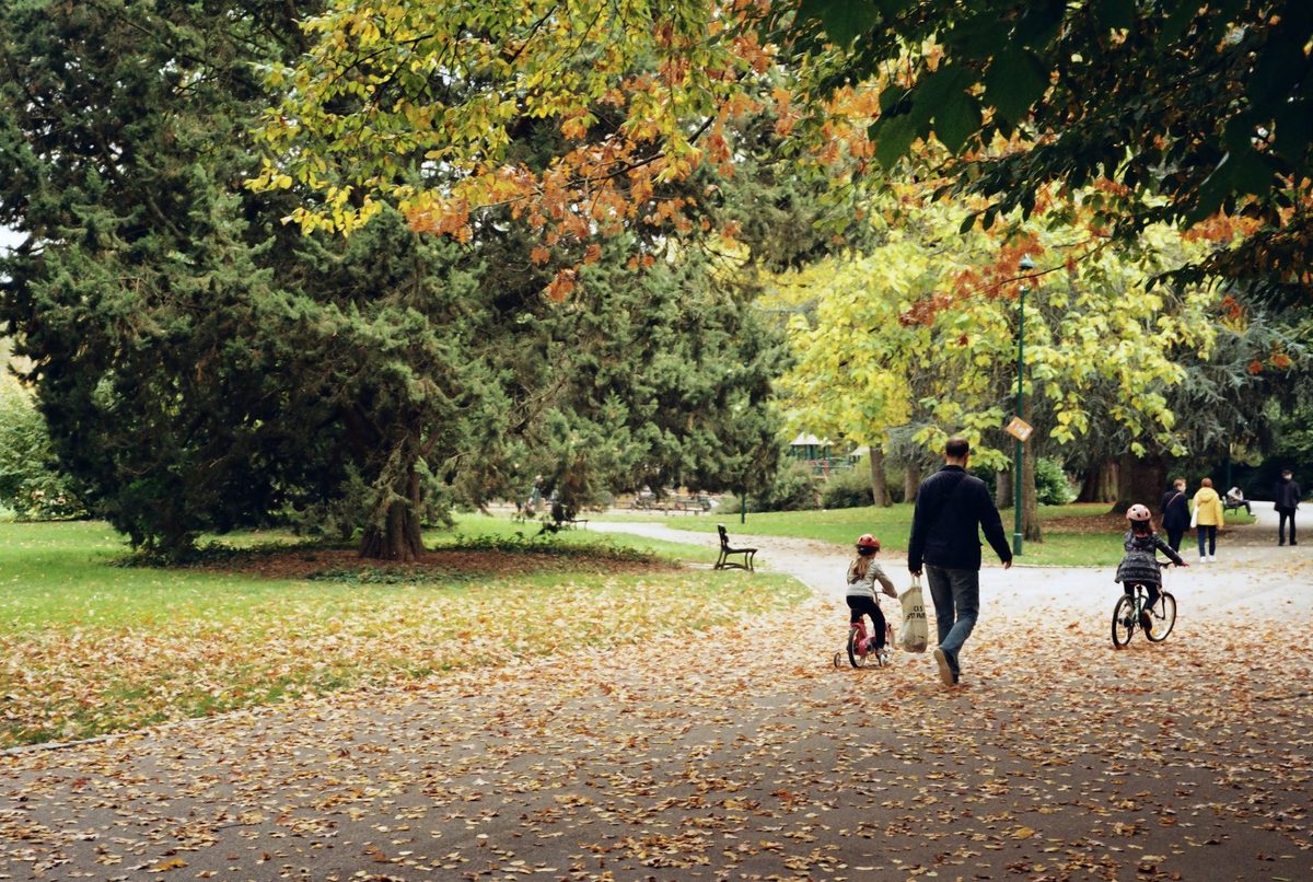 A family cycling together on a flat traffic-free path near Geneva