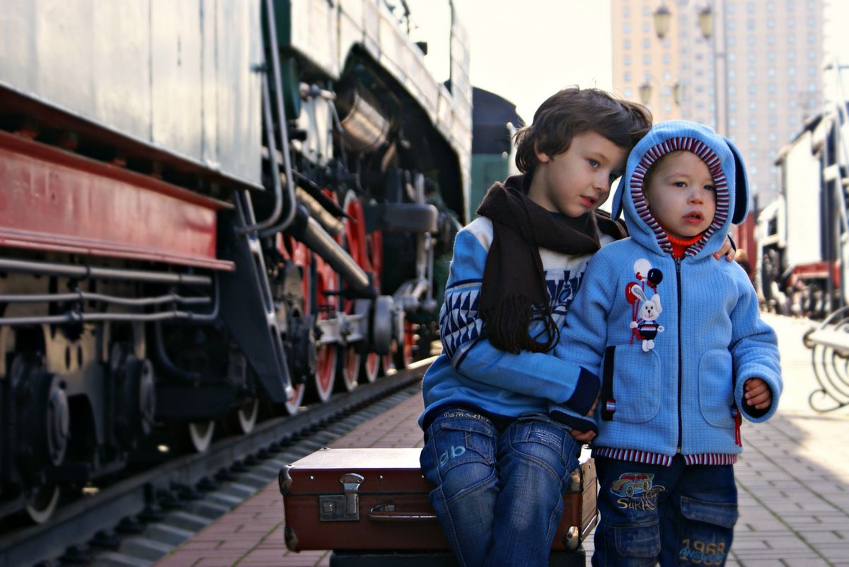 Family boarding a Swiss train for a day trip from Geneva