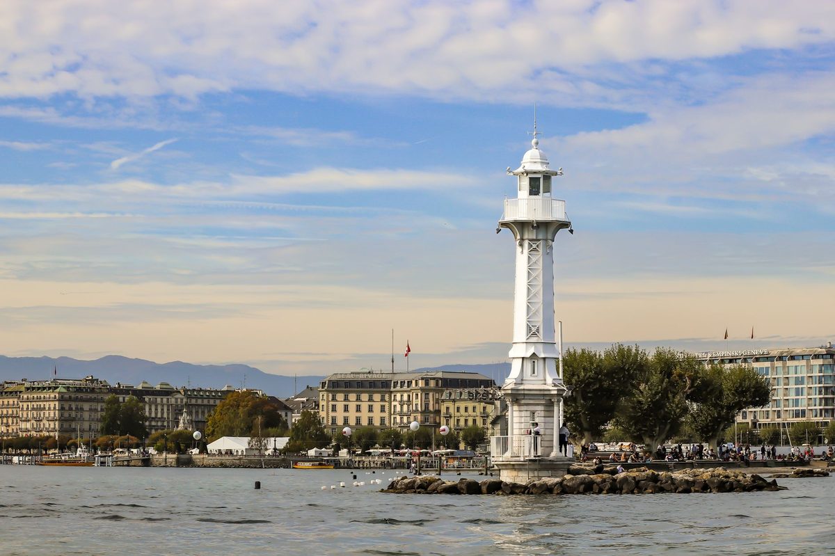 Lakeside park promenade in Geneva with the Alps in the distance