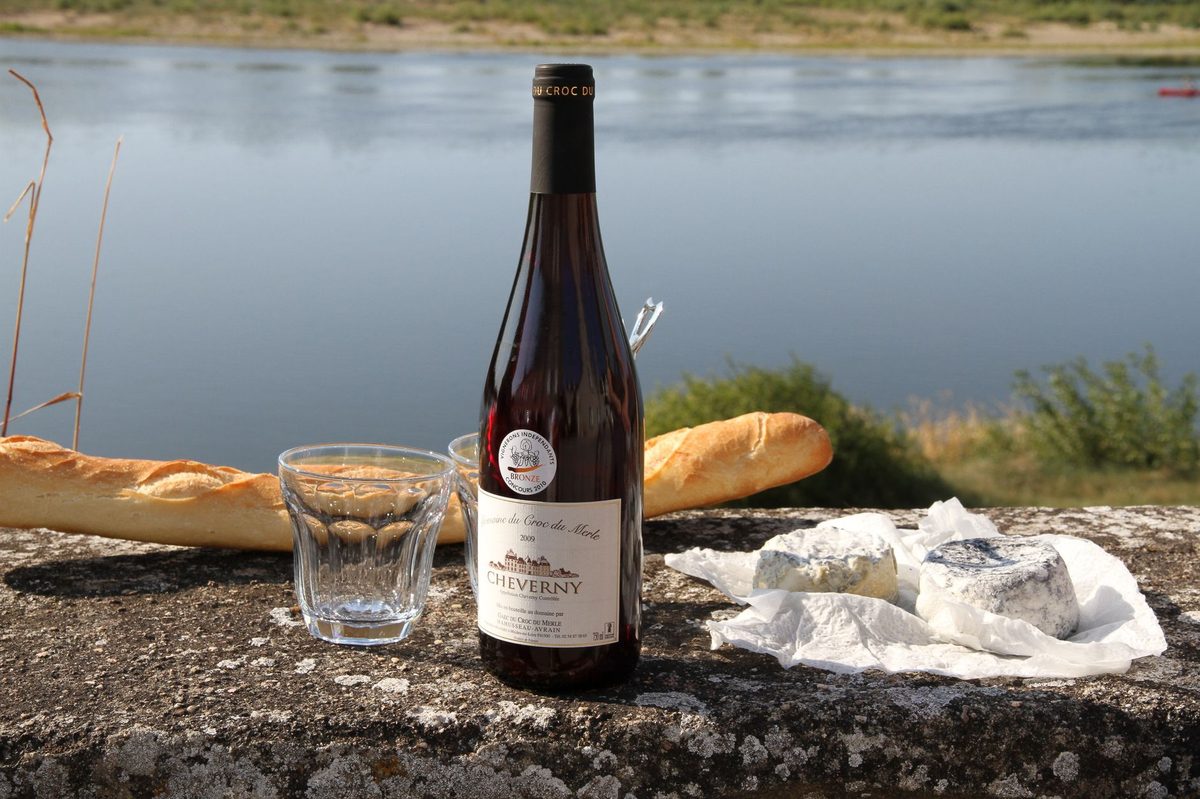 A lakeside picnic of bread, cheese and wine, the cheapest way to eat in Geneva