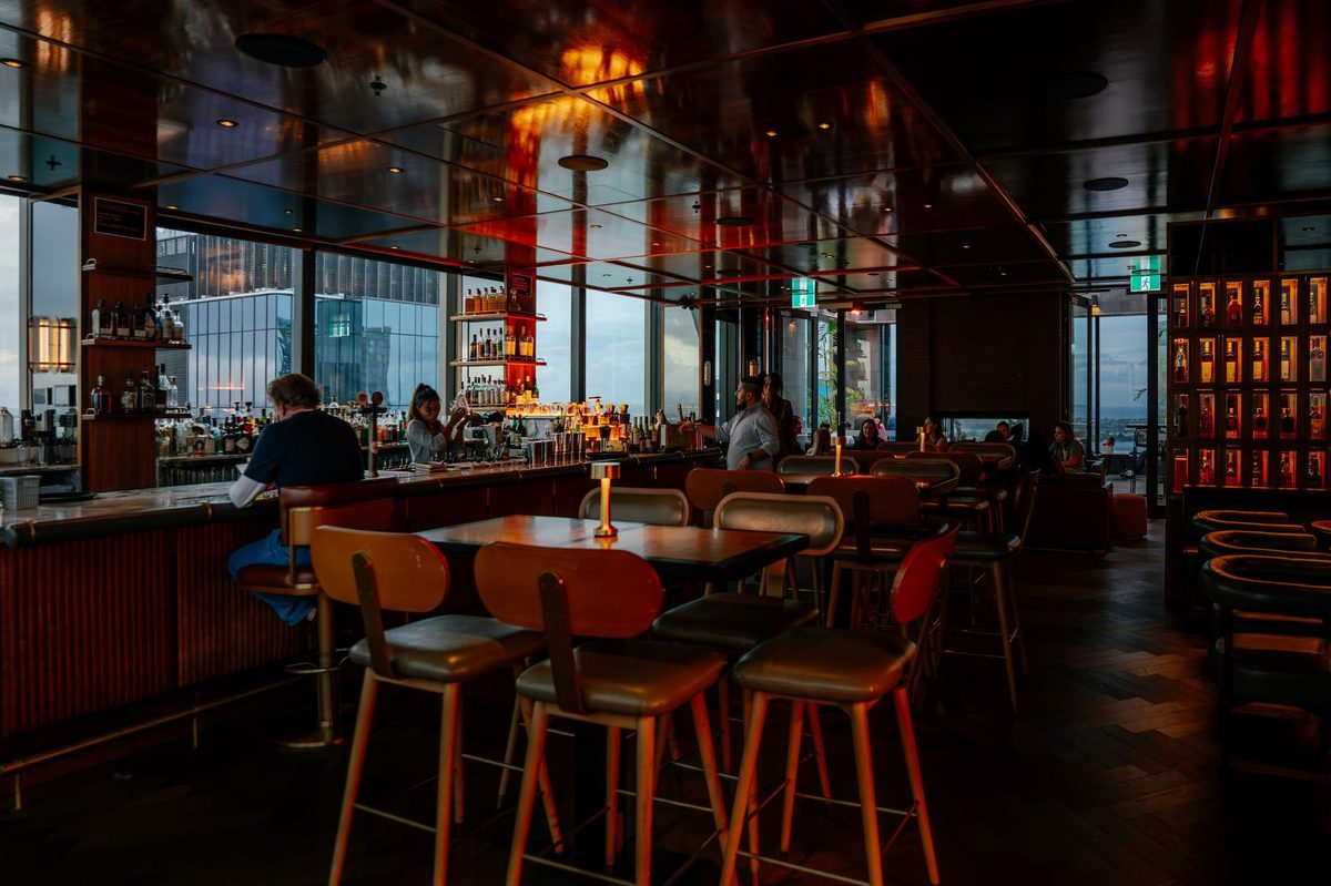 A rooftop bar overlooking Geneva and the lake at dusk