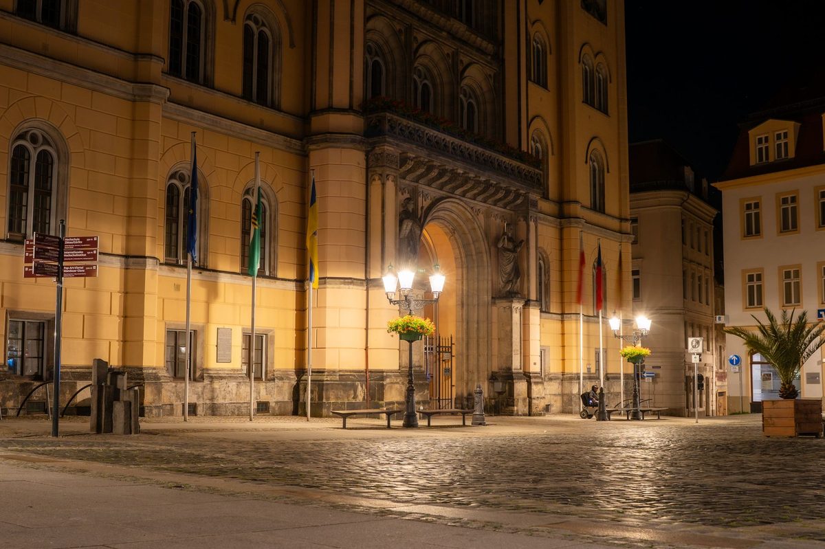 A cobbled Geneva Old Town street lit at night, the setting for the Escalade procession