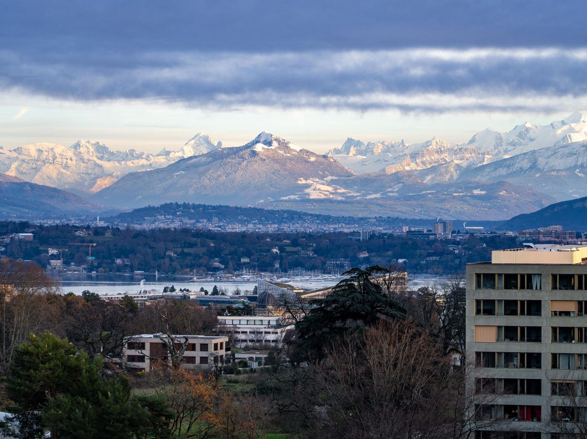 Lake Geneva with the mountains behind, a reminder to pack layers for changeable weather