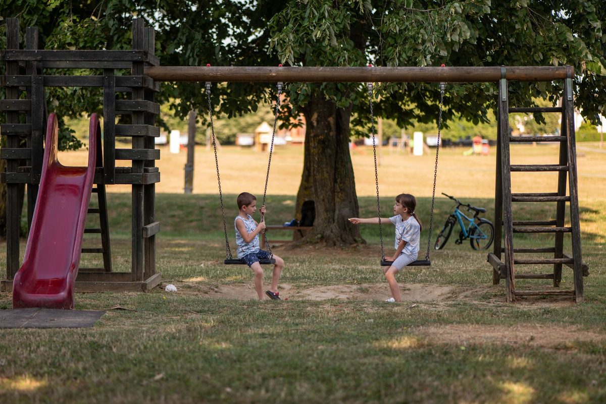 Children on a shaded playground in a Geneva park such as Parc Bertrand