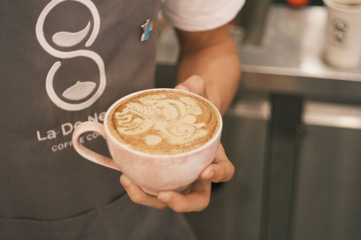 Latte art on a wooden table at a Geneva specialty coffee shop