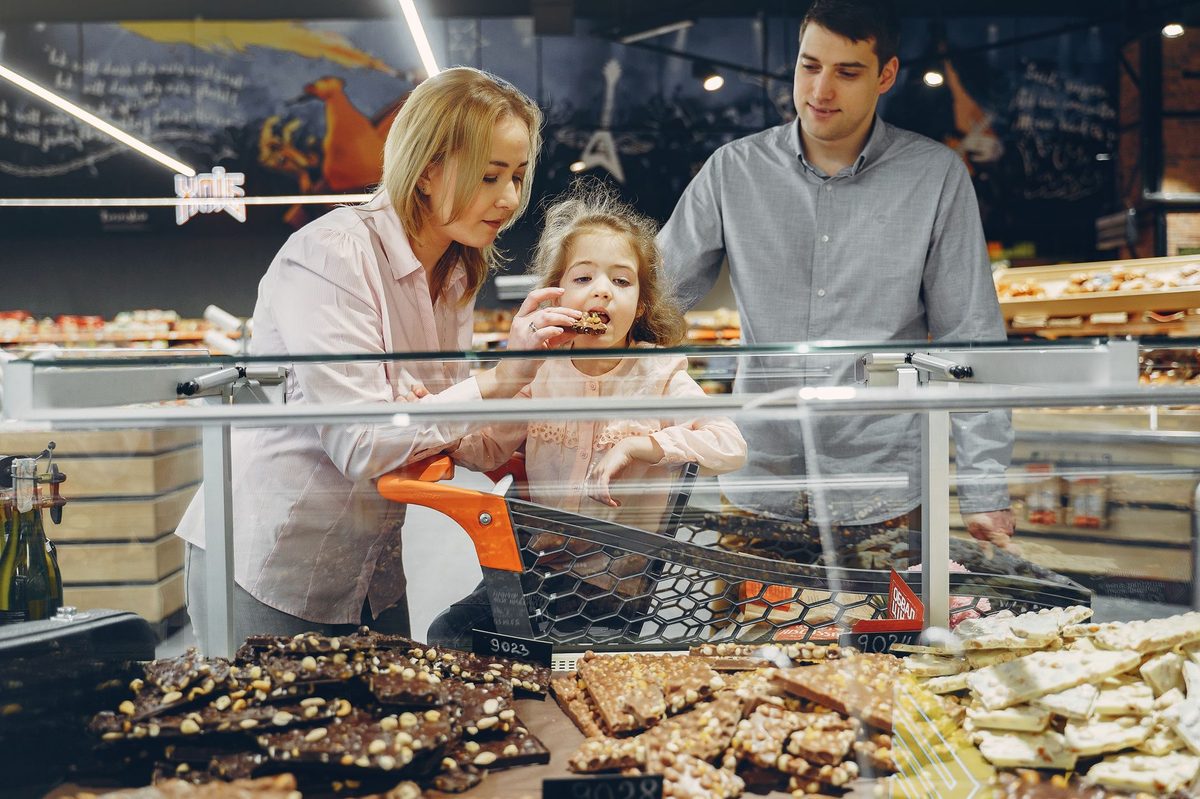 A child choosing Swiss chocolate at a Geneva chocolatier