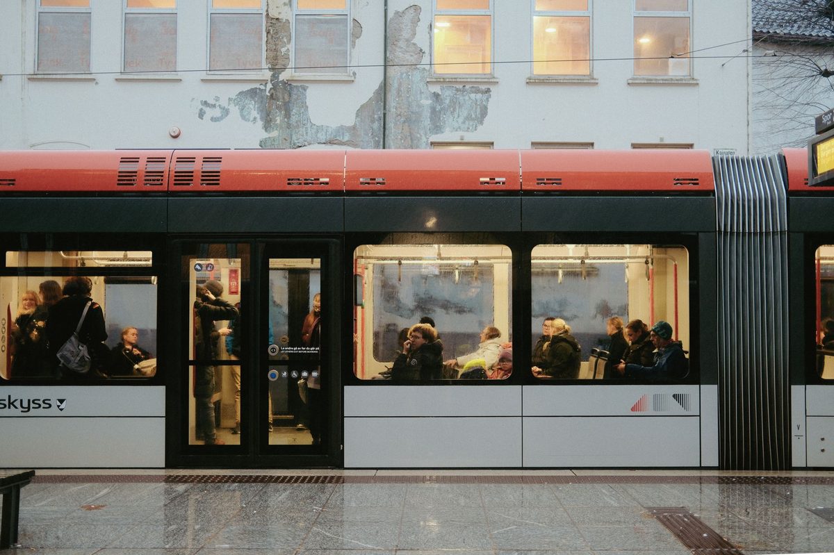 Passengers boarding a tram at a Geneva stop, part of the Unireso ticket network