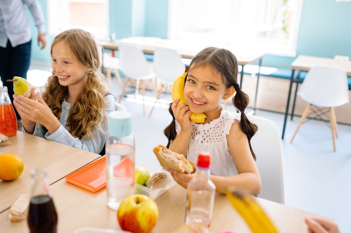 Students eating lunch at a cafeteria, like the cheap University of Geneva canteen at Uni Mail