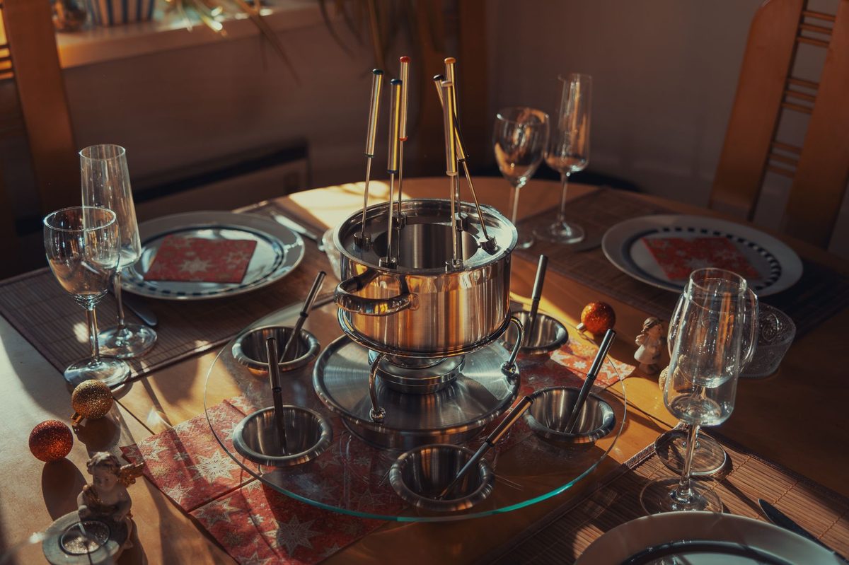 A pot of Swiss fondue on a winter dinner table in Geneva