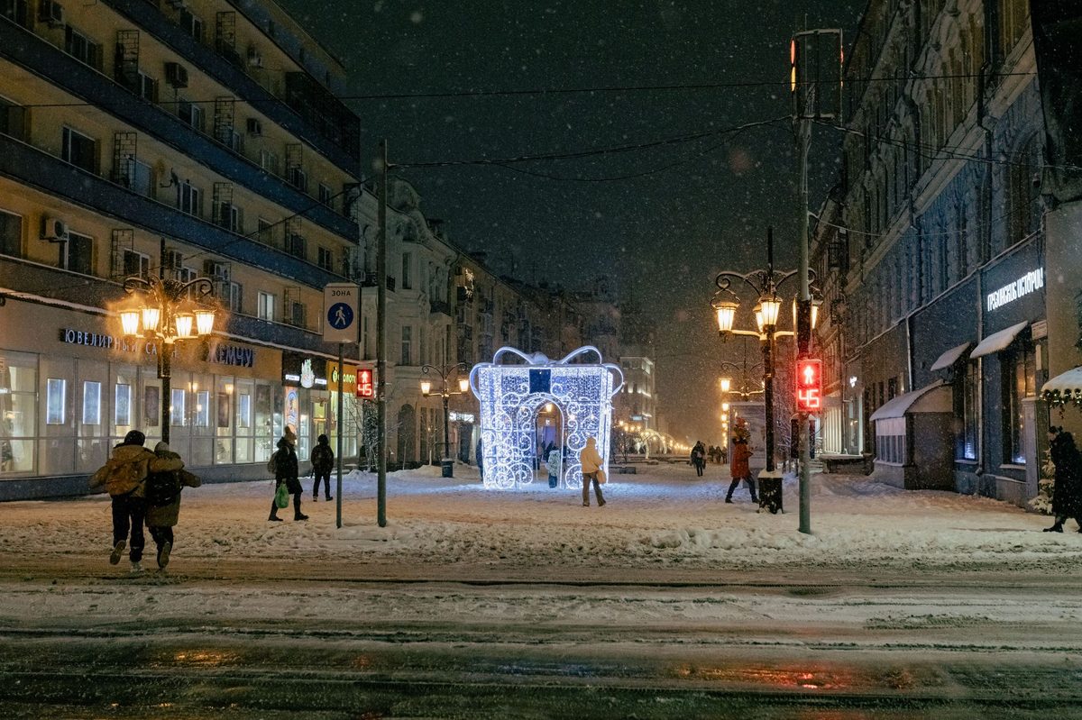 Snow-dusted Geneva street lit up on a winter evening