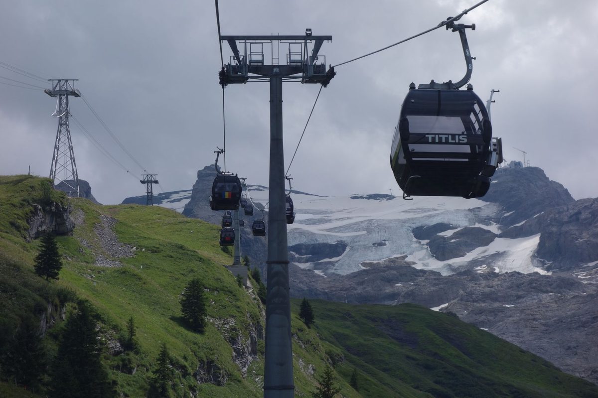 Cable car climbing to the snowy Glacier 3000 above Les Diablerets