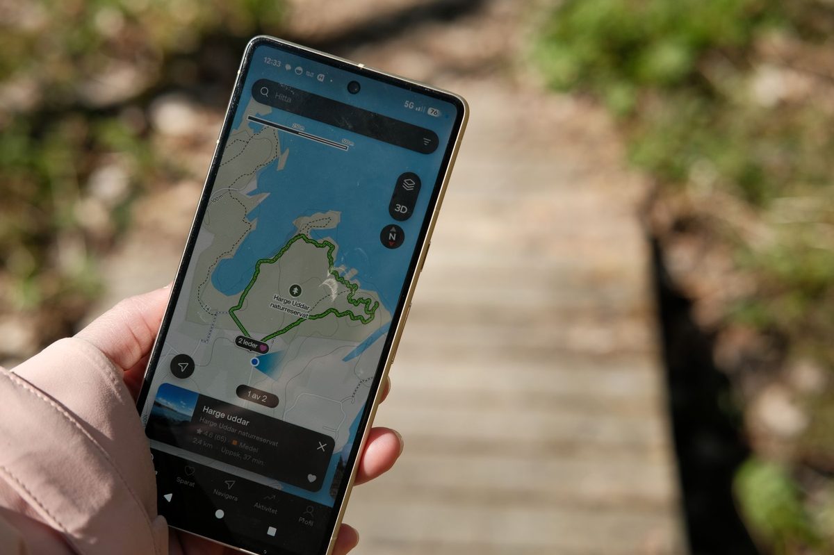 Checking a hiking route on a phone app, the easiest way to navigate trails near Geneva