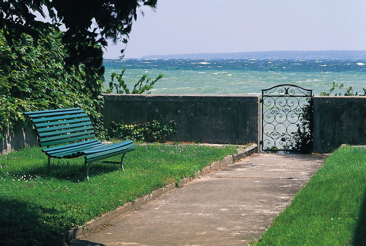A lakeside bench on Lake Geneva, the kind of free picnic spot a cheap day trip rewards