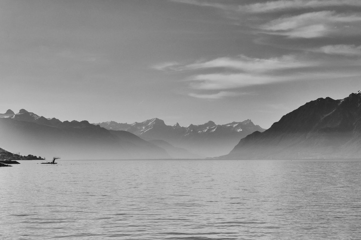 Sunrise over calm Lake Geneva water seen from the Geneva waterfront