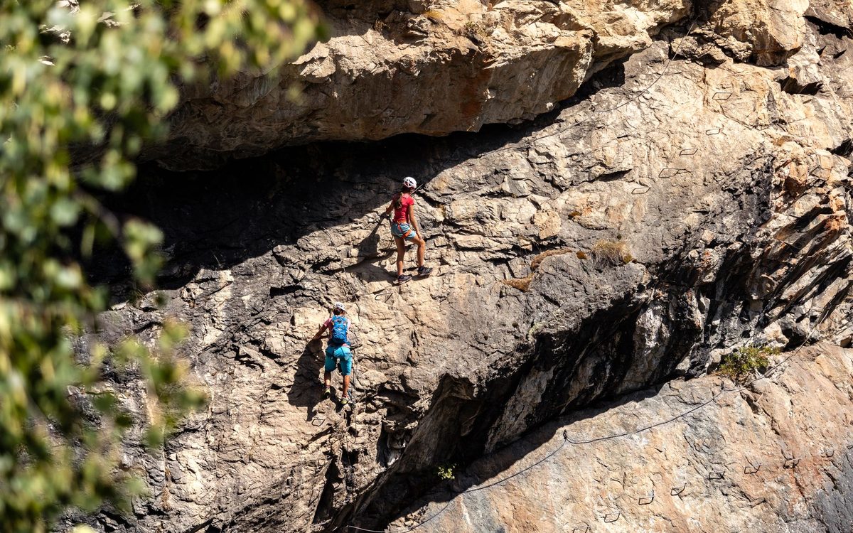 Climber on a via ferrata route on the limestone south face of Mont Saleve