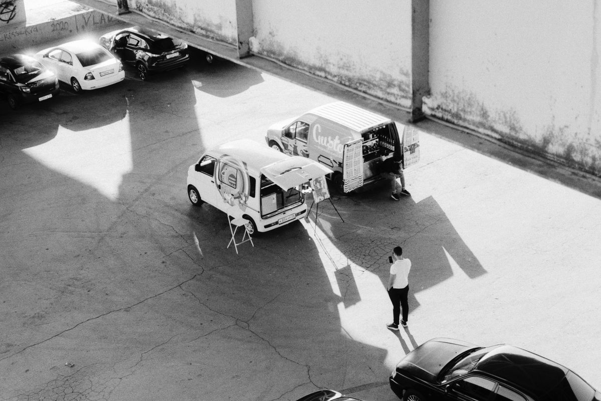Cooked-food trucks serving cheap international lunches at the Plainpalais market in Geneva
