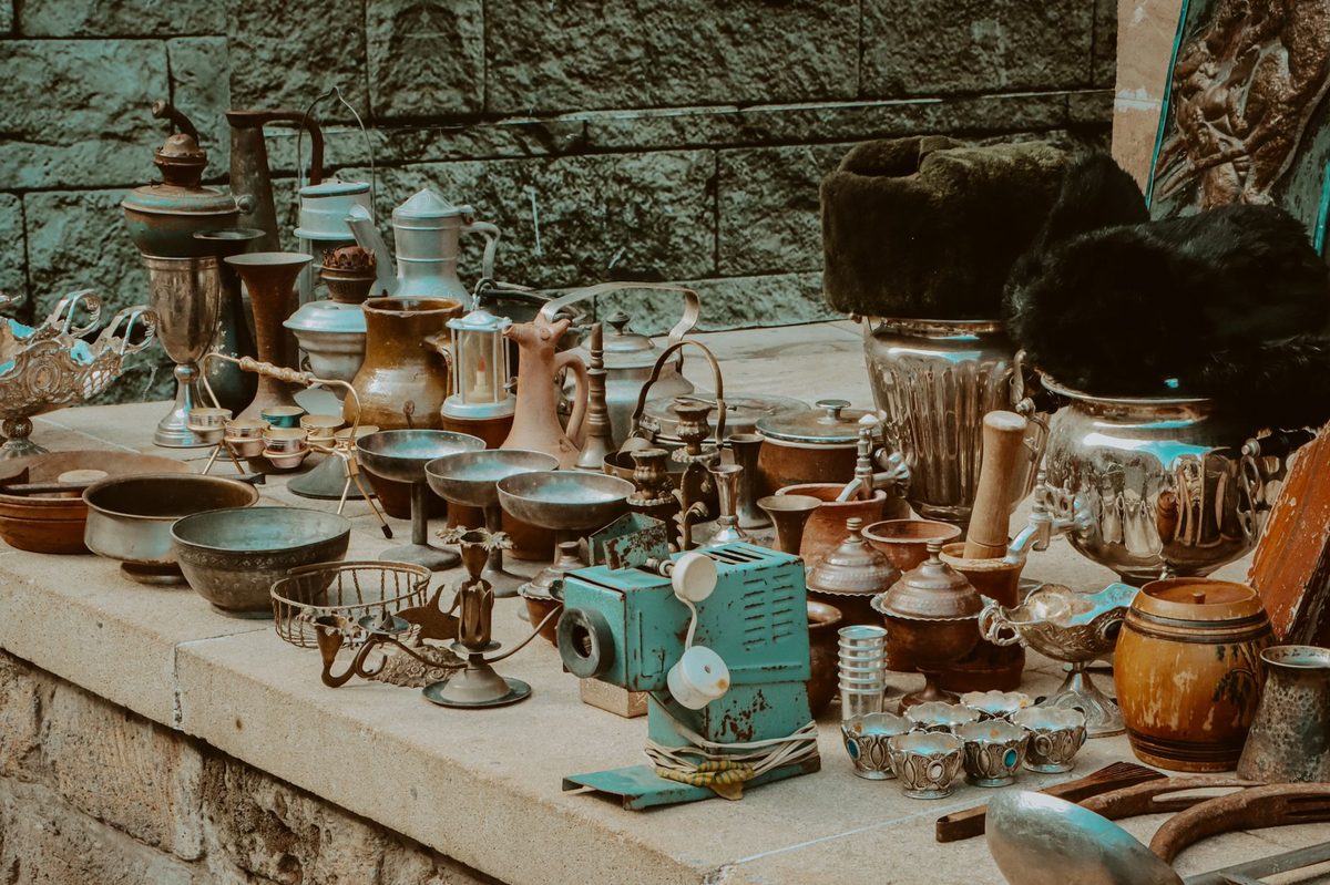Vintage brass instruments and ceramics on a Geneva flea-market stall
