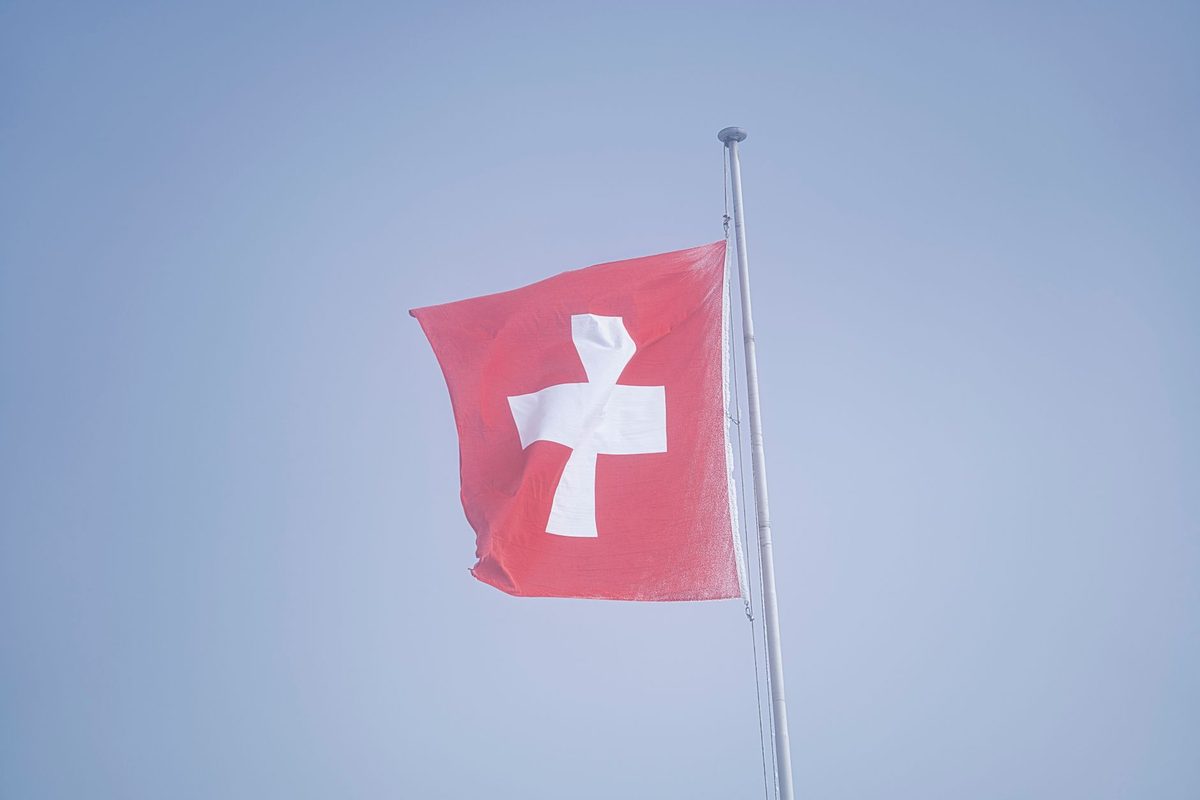 The red cross on white emblem, the inverse of the Swiss flag, symbol of the Red Cross founded in Geneva