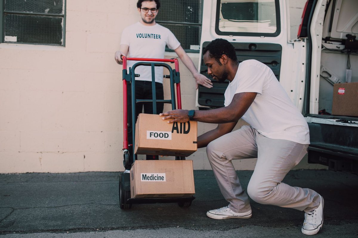 Red Cross volunteers delivering relief, the work the Geneva-born movement coordinates worldwide