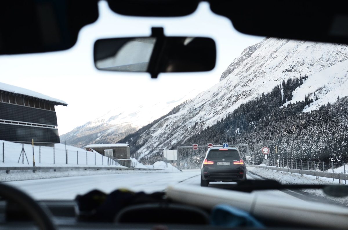 A car on a scenic Swiss Alpine road, the reason to rent a car in Geneva