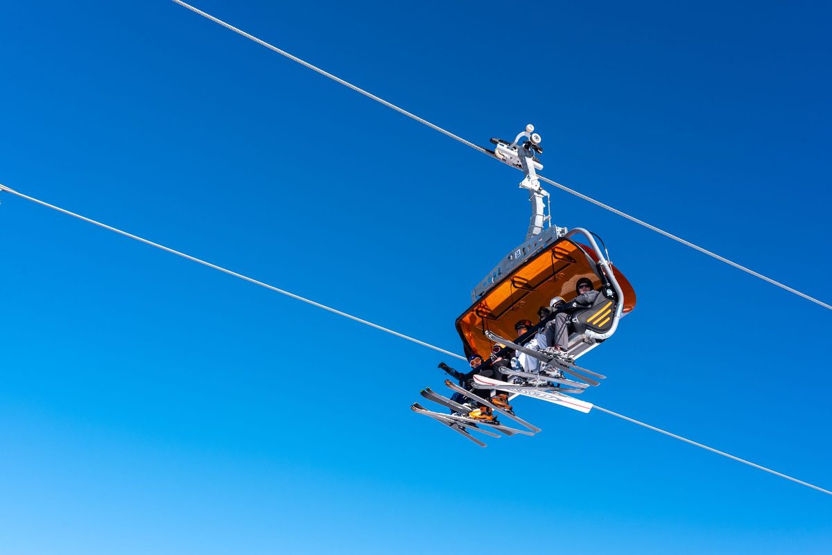 Chairlift rising over snowy pistes at a ski resort near Geneva in the French Alps