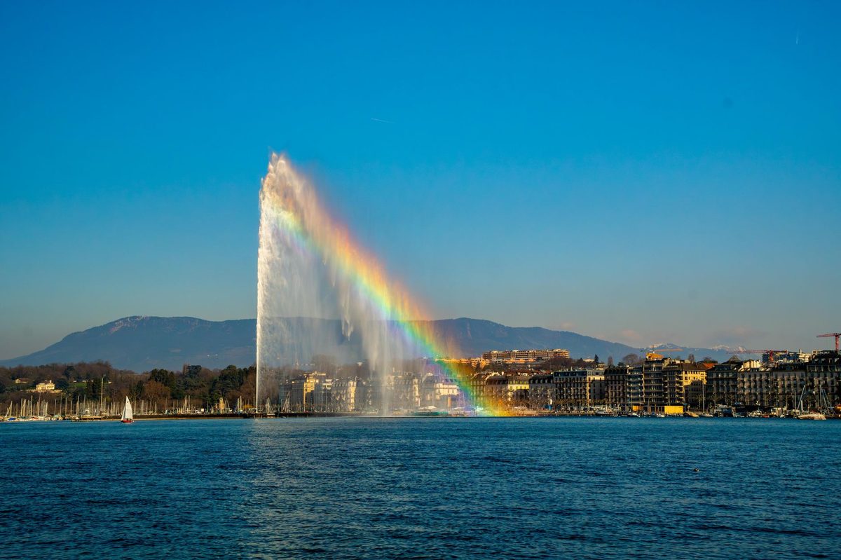 Geneva's Jet d'Eau and lakefront lit up at night