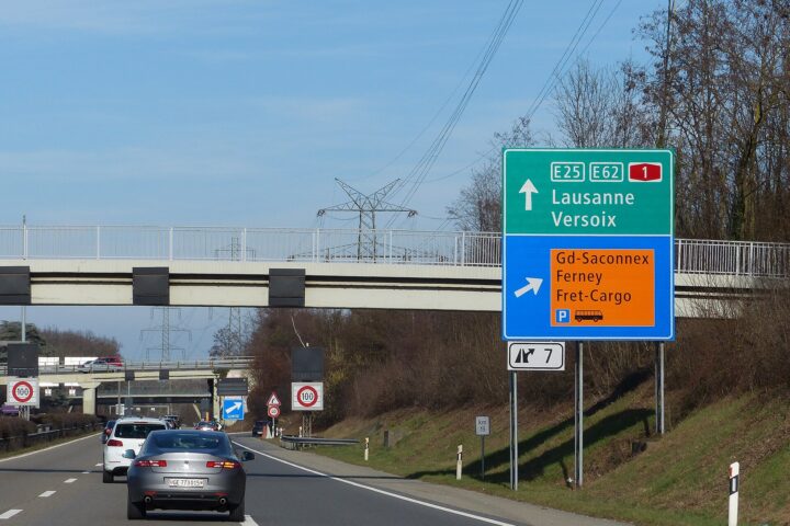 Motorway sign for exit 7 on the Swiss A1 beside Geneva Airport, pointing to Grand-Saconnex, Ferney and the cargo area