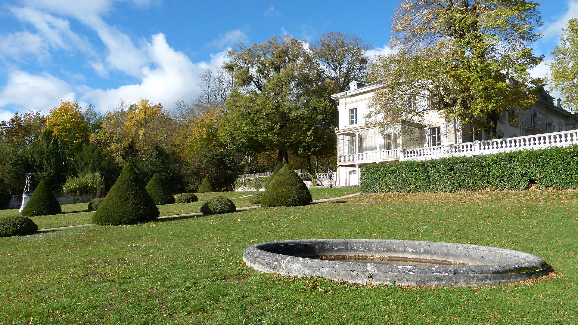 The Chateau de Voltaire at Ferney-Voltaire with its formal garden and stone basin in autumn