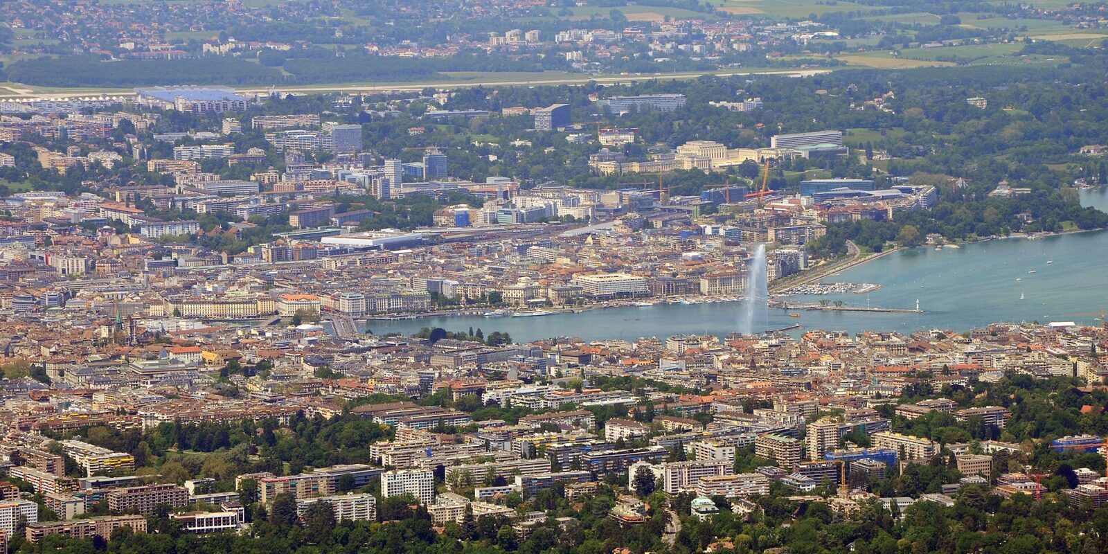 Geneva seen from the Saleve with the lake, the Jet d'Eau and the airport runway in one view