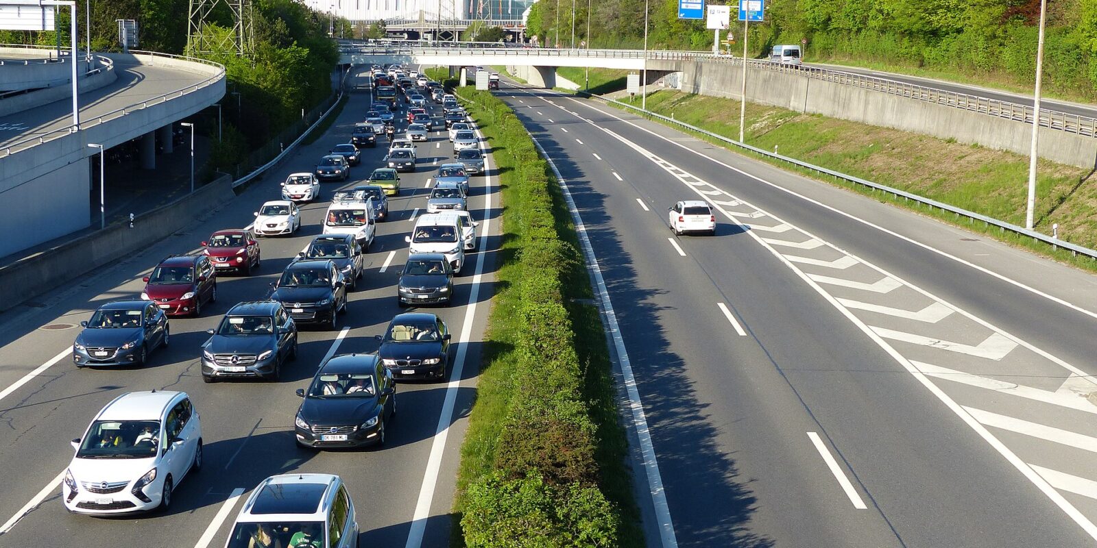 Queuing traffic on the A1 motorway at the Geneva Airport junction with the Palexpo hall behind