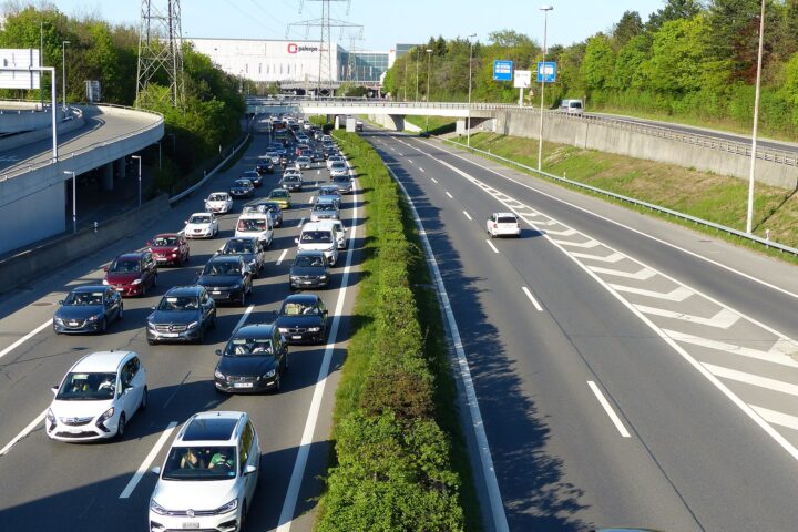 Queuing traffic on the A1 motorway at the Geneva Airport junction with the Palexpo hall behind