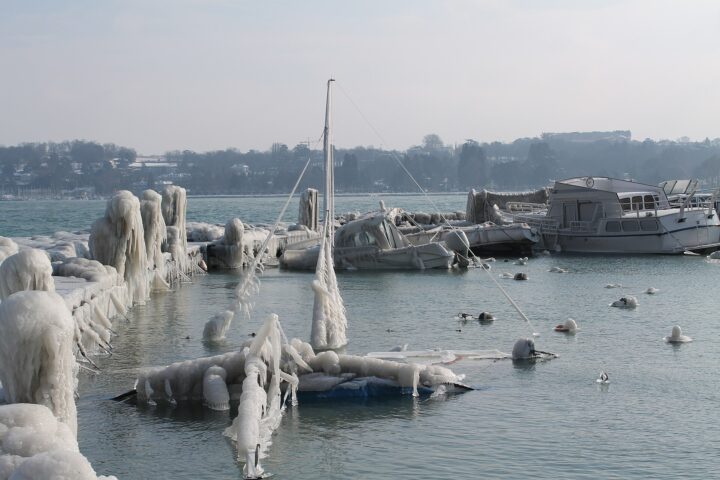 Boats, masts and mooring posts encased in thick ice from Bise spray in Geneva harbour during the February 2012 cold snap